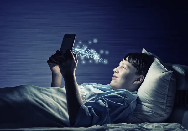 Teenager Reading in bed