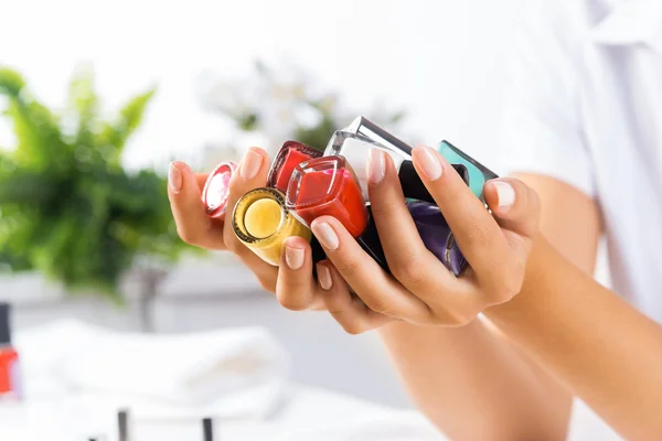 Woman hands with nail polishes