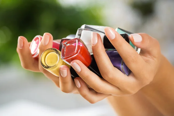 Woman hands with nail polishes