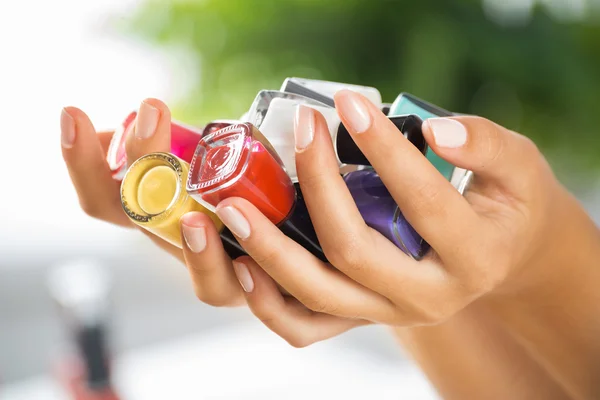 Woman hands with nail polishes