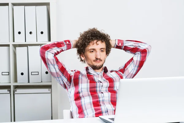 Young relaxed man in  office