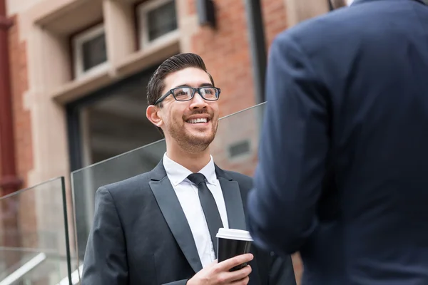 Businessmen taking coffee break