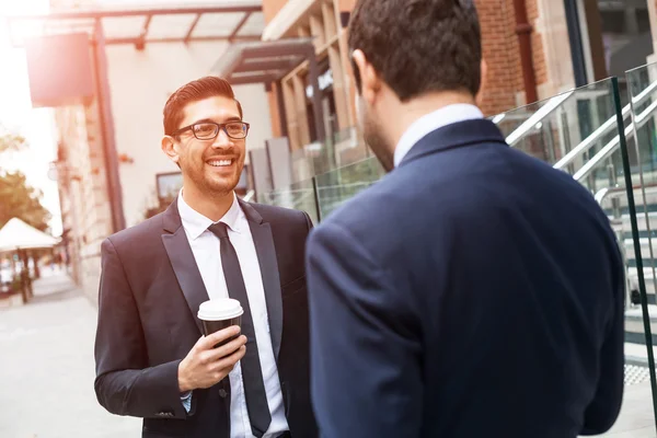 Businessmen taking coffee break