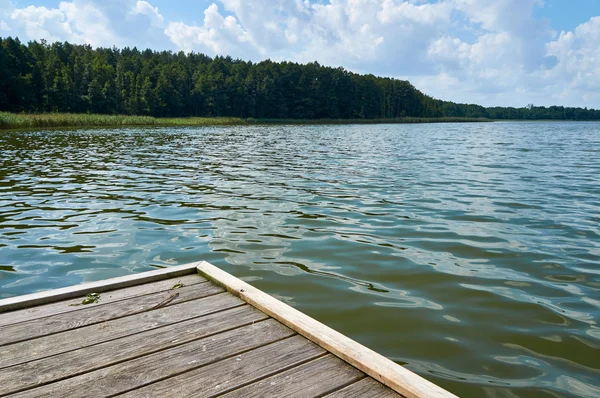 Empty footbridge over beautiful Lemiet lake in Mazury district, Poland. Fantastic travel destination.