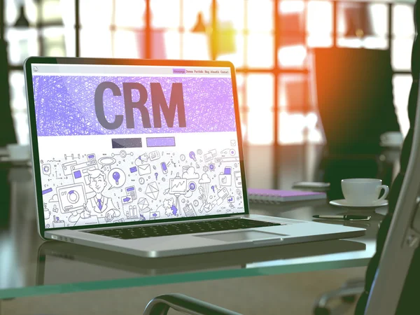 CRM on Laptop in Modern Workplace Background.