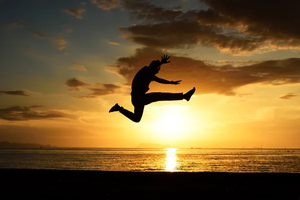 Silhouette of jumping man on beach