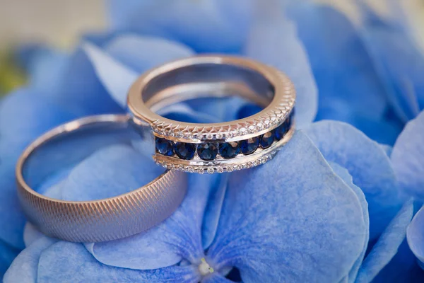 Wedding rings on the blue flowers