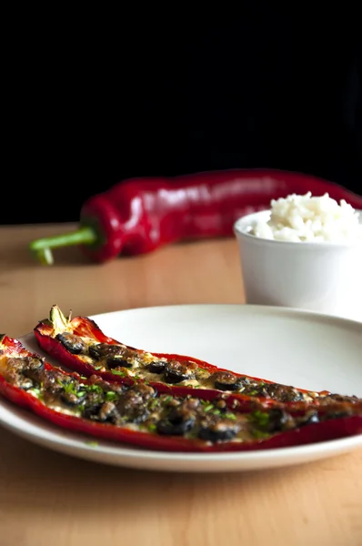 Baked bell pepper with cheese and olives, rice in bowl