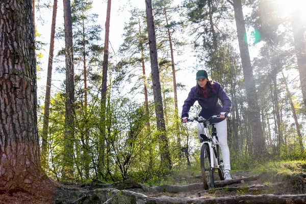 Bike riding - woman on bike in forest