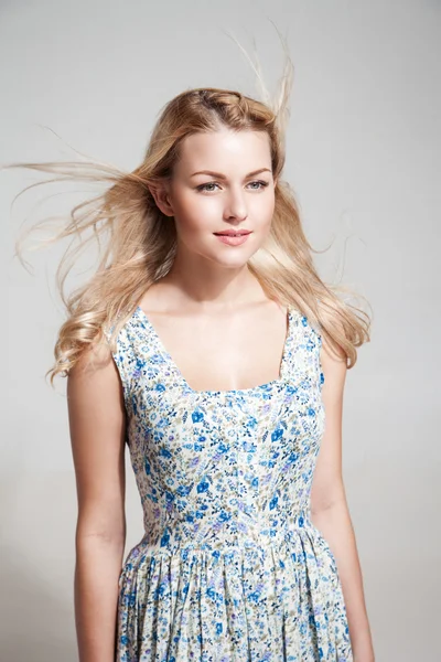 Portrait of beautiful young woman with windy hair