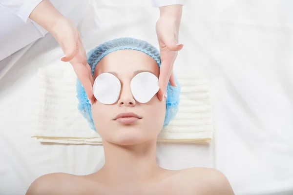 Woman getting face treatment in medical spa center