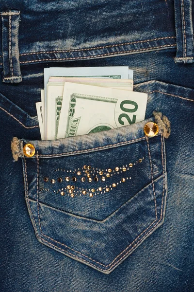 Money sticks out of the pocket of his jeans with rhinestones