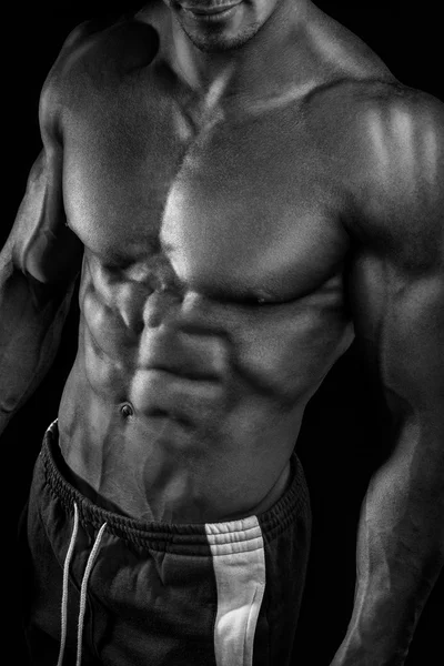 Strong athletic man fitness model showing torso muscles