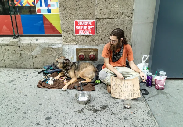 Homeless with his dog in New York Street