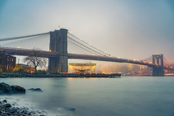 Brooklyn bridge at foggy evening