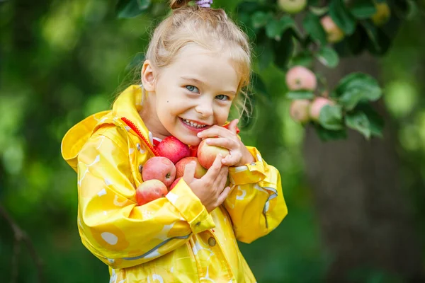 Little girl in the apple garden