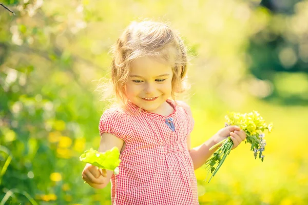 Happy little girl in spring sunny park