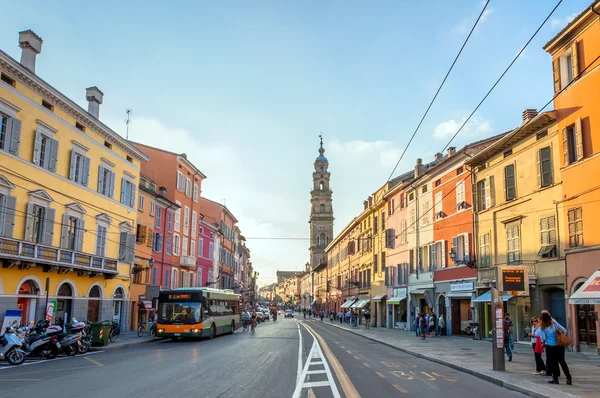 main street with shops and people in Parma, Italy