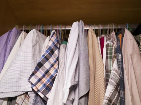 Clothes hang on a shelf