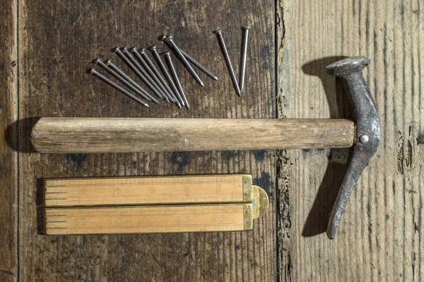 Vintage hammer, nails and wooden centimeter