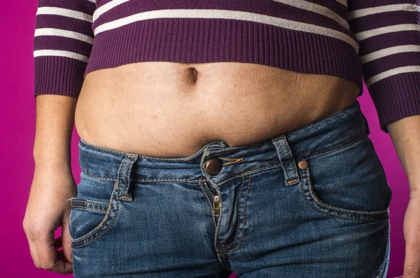 Woman with jeans shows belly