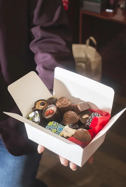 Hands holding box of chocolates