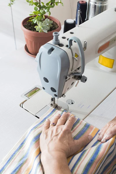 Woman sew on sewing machine