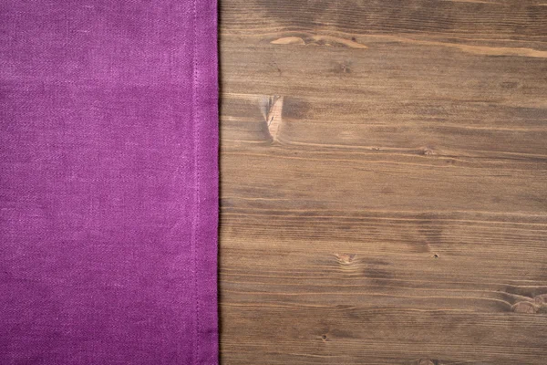 Purple  napkin from left side wooden table