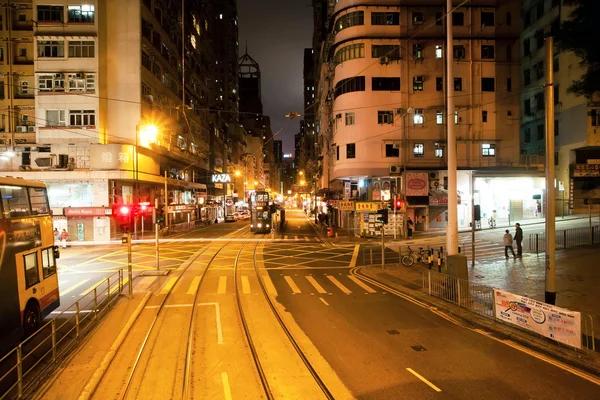 Night streets with skyscrapers and double-decker on dark road