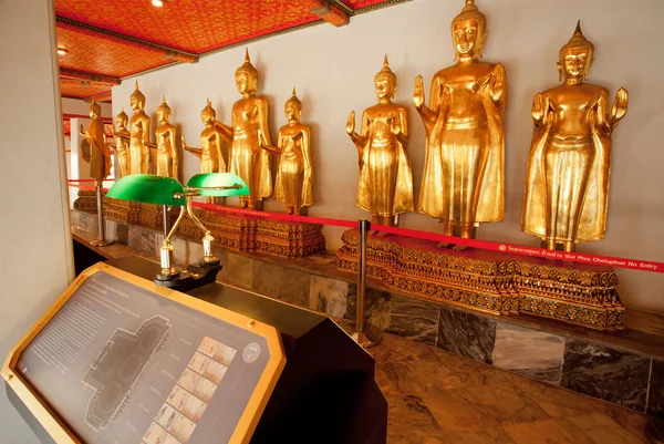 Golden sculptures of Buddha inside museum of historical monastery