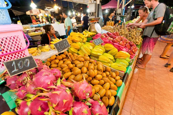 Dragon fruit and other exotic fresh products selling by street vendors on big city market
