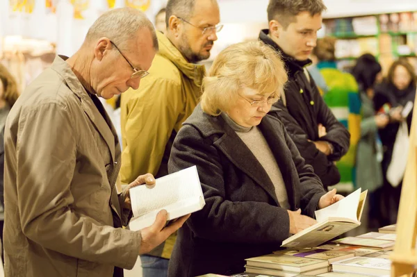 Seniors reading new books with interest