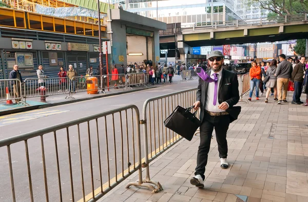 Happy businessman walking on busy business area of huge asian city