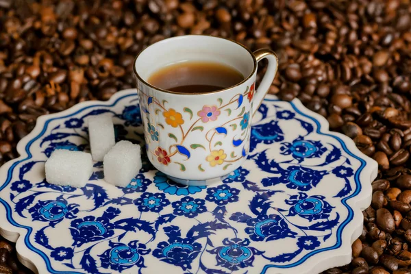 Turkish ceramics in ancient style. Morning cup of coffee on carved platter