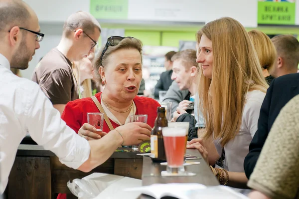 Women talking and drinking beer at bar