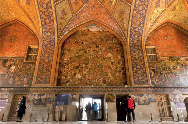 Tourists inside the historical rooms with old murals and decoration of palace Chehel Sotoun in Isfahan.