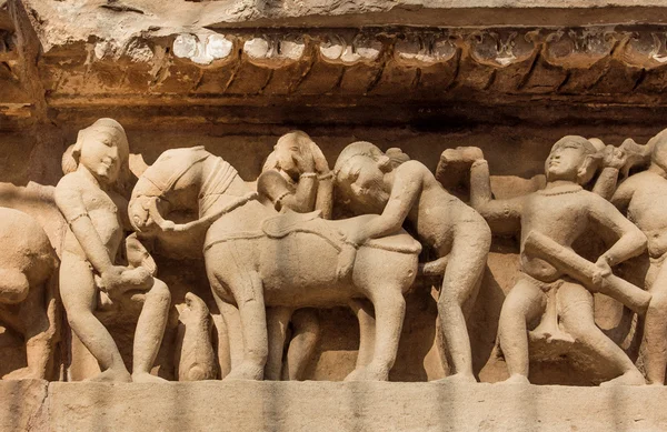 Intimate life of ancient people on stone relief on wall of Khajuraho temple, India. UNESCO Heritage site