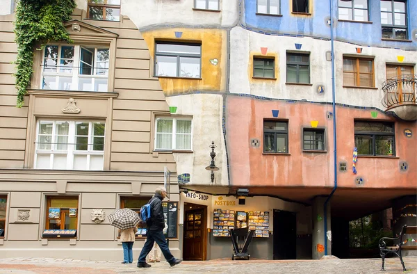Tourist walking around house built with concept of Austrian artist Hundertwasser