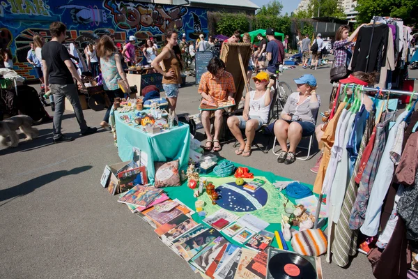 People sell the second hand jeans and used items on the open air flea market