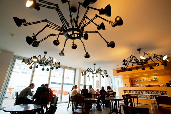 People sit at the tables in the cafe Museum of Contemporary Art