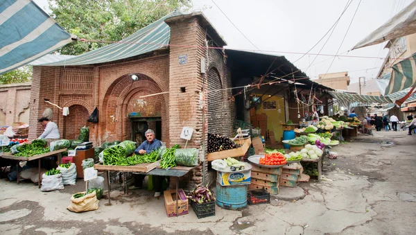 Local market traders sell vegetables and fruits