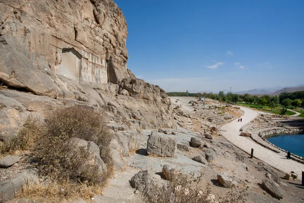 Rocks over the lake and ancient stone reliefs