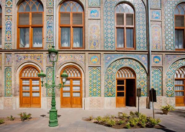 Patterned walls and wooden doors of the royal palace Golestan in Iran.