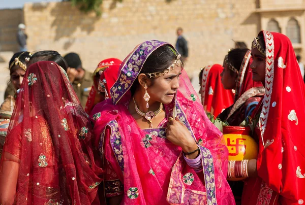 Woman in a crowd of friends dressed in sari