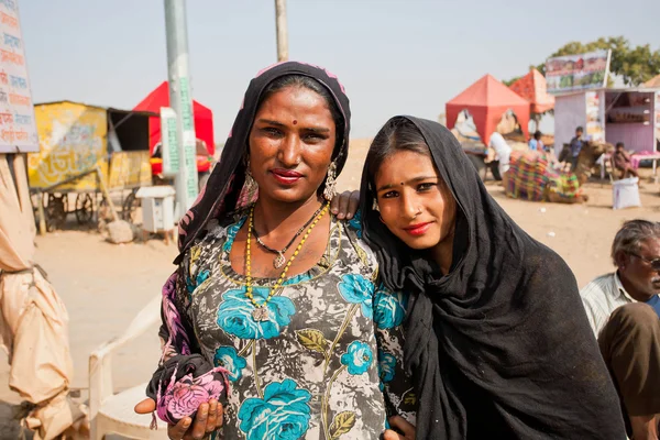 Two happy indian women possing on the village street