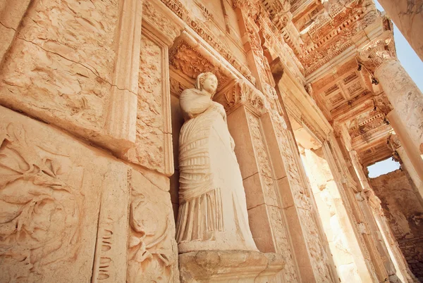 Stone body of greek goddess at entrance of historical Celsus Library in Ephesus, Turkey