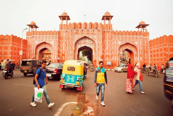 Famous 18th century Ajmeri Gate of city wall and young indians walking around vehicles