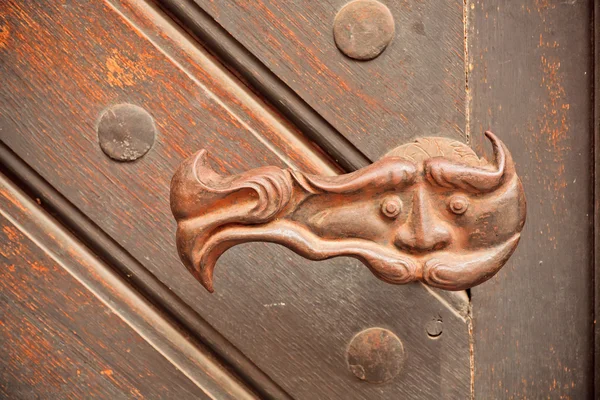 Wrought iron door handle with a mysterious person face