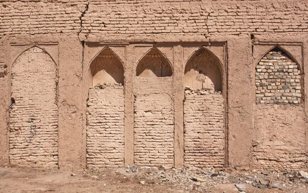 Textured wall with bricked-up niches in house of the Middle East