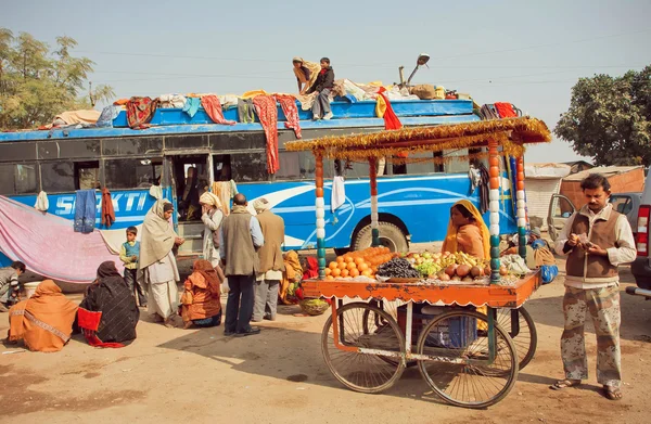 Many people waiting for departure on bus station of small indian town